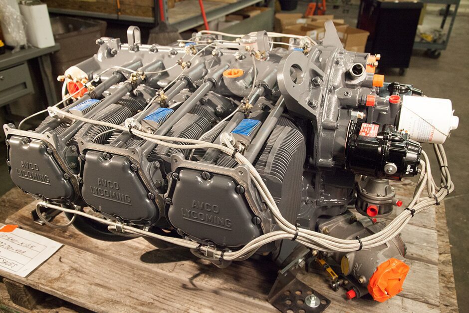 Close-up of a complex mechanical engine part on a workbench.