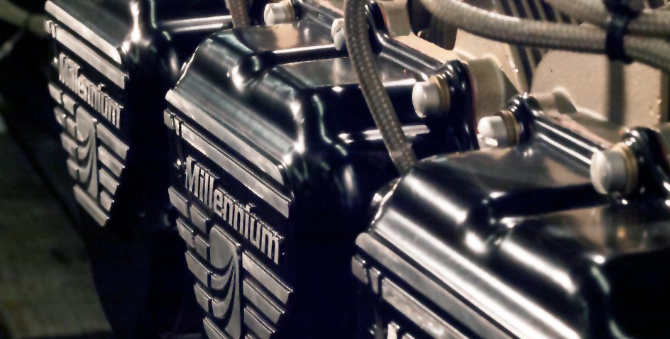 Close-up of a motorcycle engine with Millennium branding.